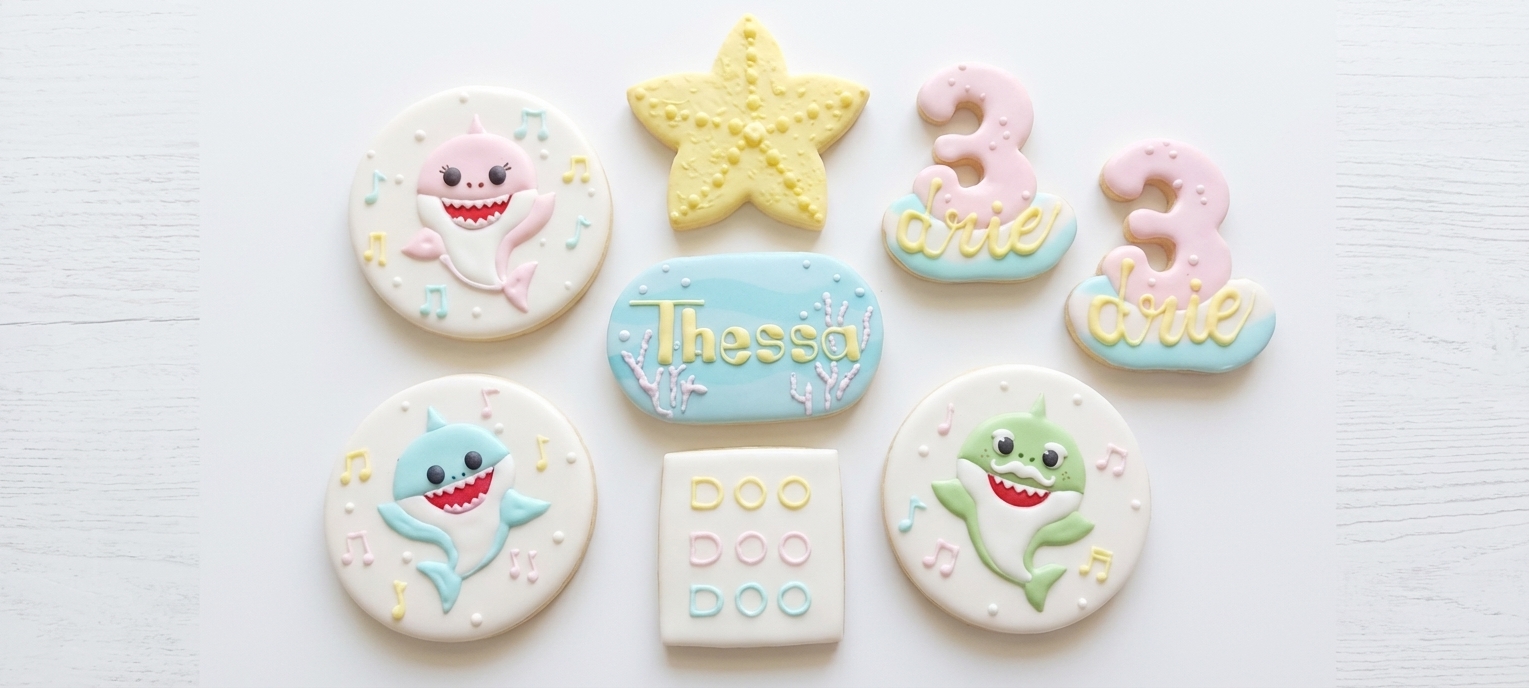 Baby Shark themed royal icing cookie set — sharks, stars and number cookies